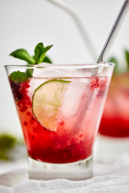 Elderflower raspberry lime mocktail garnished with fresh mint leaves