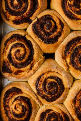 Freshly baked cinnamon rolls in a baking tin