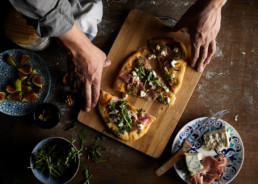 Freshly made rustic pizza with figs, prosciutto and goat cheese