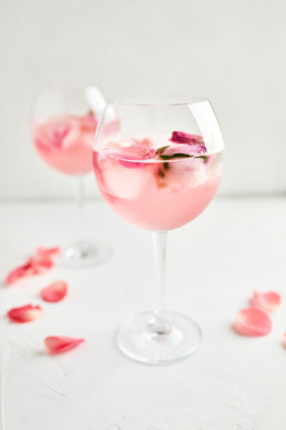 Gin and tonic cocktail with rose infused tonic and frozen roses