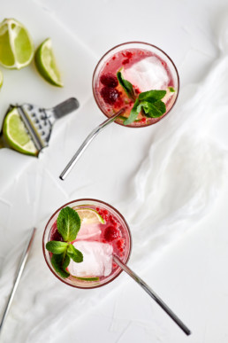 Elderflower raspberry lime mocktail garnished with fresh mint leaves