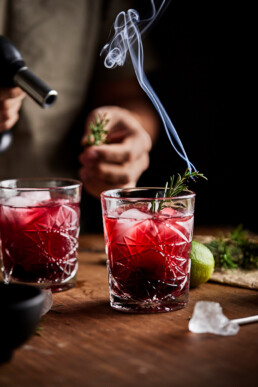 Burning the sprigs of rosemary as a garnish for mocktail