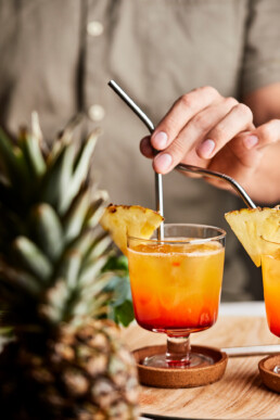 Pineapple sunrise mocktail with steel straws