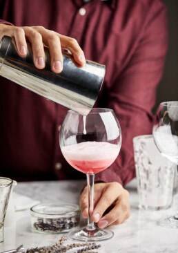 Pouring mocktail into a glass