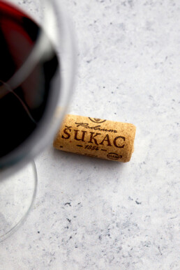 Wine cork with glass of merlot